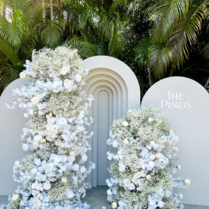 white floral wedding photo-op with custom arches